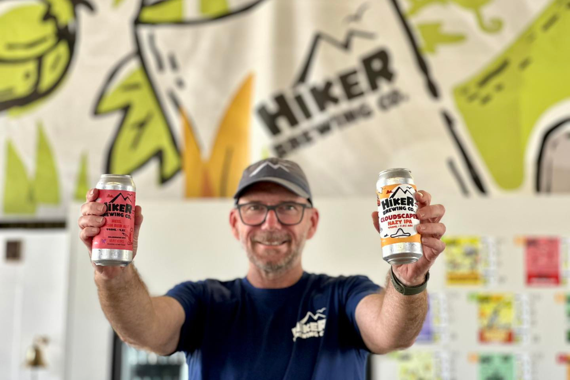 Owner Phil Sharp with a couple of cans at Hiker Brewing Concern craft brewery in Salisbury, Brisbane